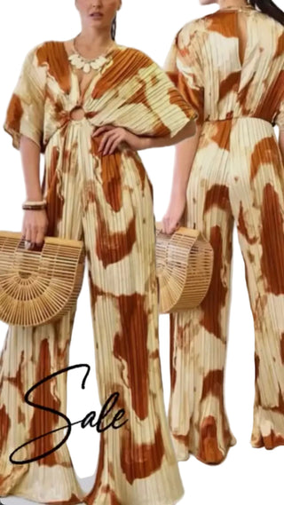 A woman modeling a pleated jumpsuit with a brown and cream tie-dye pattern, shown from both front and back angles against a light gray studio background. She is holding a woven straw clutch, and a large 'Sale' text overlay is visible at the bottom.
